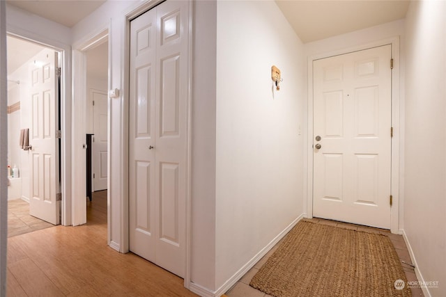 corridor with light hardwood / wood-style floors