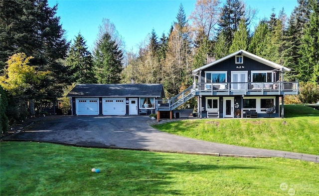 front of property with a deck and a front lawn