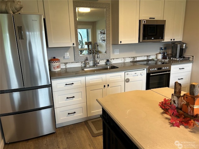 kitchen featuring white cabinetry, sink, dark wood-type flooring, and stainless steel appliances