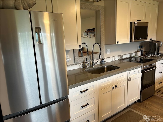 kitchen featuring white cabinetry, sink, dark hardwood / wood-style flooring, and appliances with stainless steel finishes