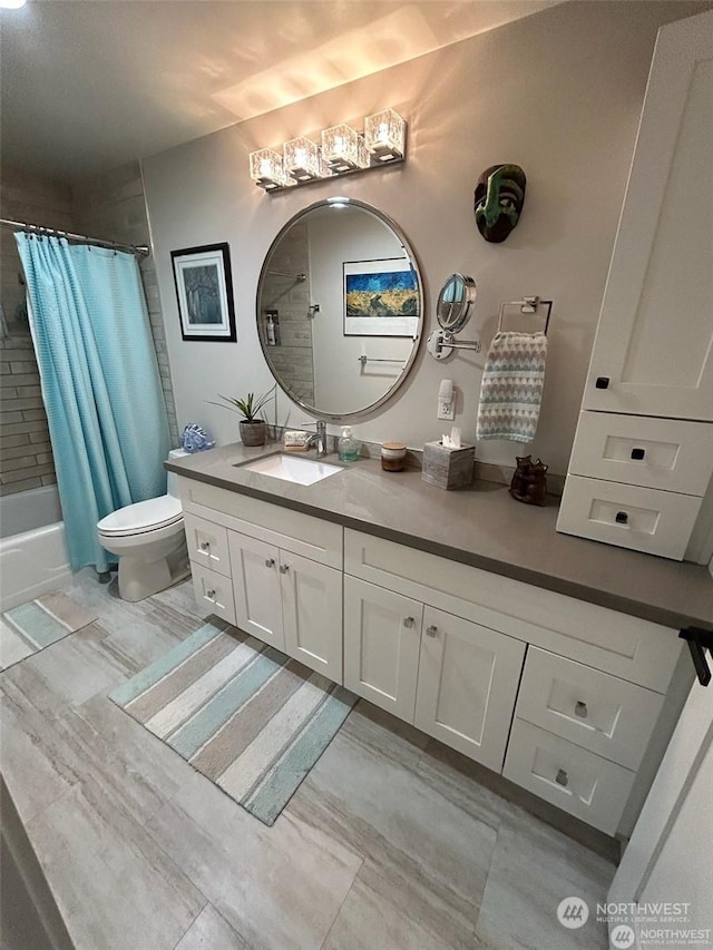 full bathroom featuring shower / bath combination with curtain, vanity, and toilet