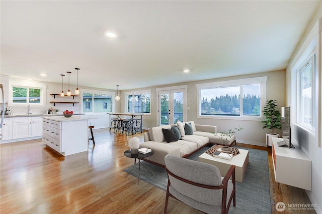 living room featuring light wood finished floors and recessed lighting