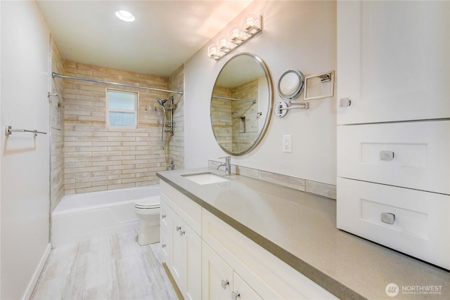 bathroom featuring shower / bath combination, vanity, and toilet