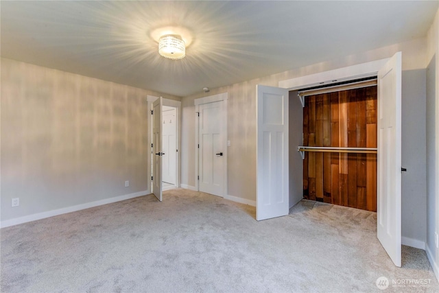 unfurnished bedroom with carpet floors and baseboards