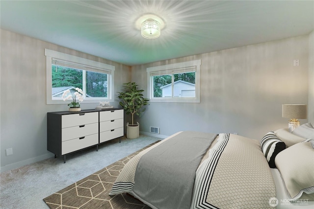 carpeted bedroom with visible vents and baseboards