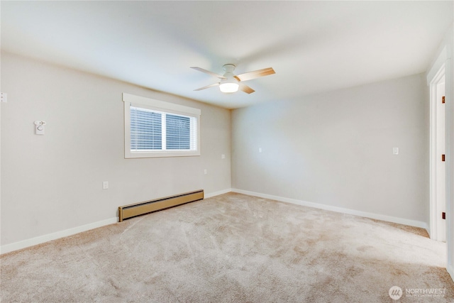 spare room featuring a ceiling fan, a baseboard radiator, baseboards, and carpet