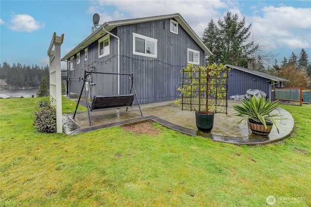 back of house featuring a yard and a patio area