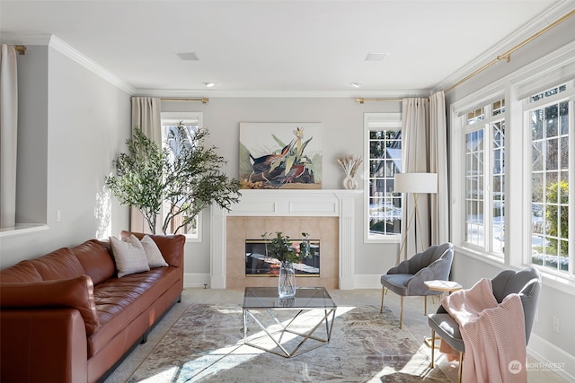 living room with ornamental molding and a tiled fireplace