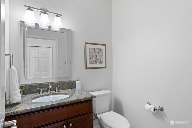 bathroom with vanity and toilet