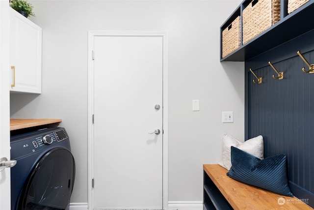 washroom with washer / clothes dryer and cabinets