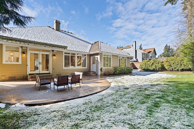 rear view of house featuring a patio, a lawn, and french doors