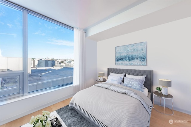 bedroom with hardwood / wood-style flooring