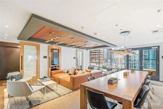 dining room with light hardwood / wood-style flooring and french doors