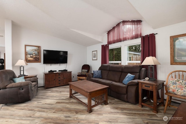 living room featuring lofted ceiling and hardwood / wood-style floors