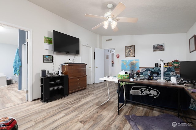 office featuring vaulted ceiling, ceiling fan, and light hardwood / wood-style flooring