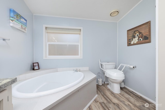 bathroom featuring hardwood / wood-style floors, crown molding, toilet, and a bathing tub