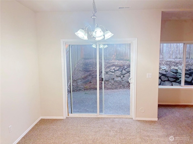 unfurnished dining area with an inviting chandelier and carpet flooring