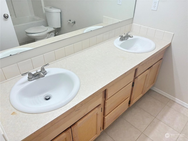 bathroom with tile patterned flooring, vanity, backsplash, and toilet