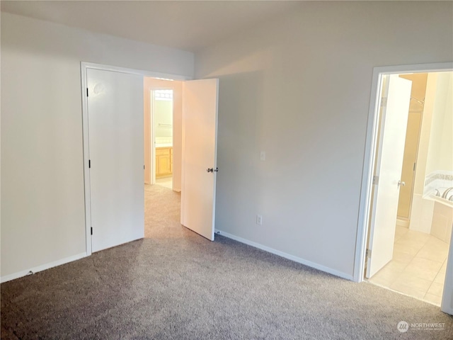 unfurnished bedroom featuring light colored carpet