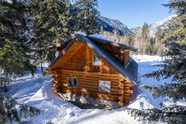 view of snowy exterior featuring a mountain view