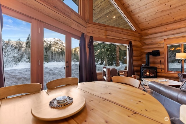 interior space with log walls, a mountain view, and a wealth of natural light