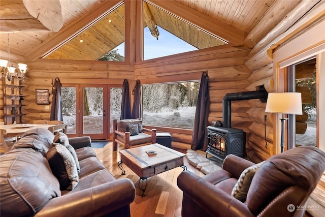 living room with beam ceiling, high vaulted ceiling, wooden ceiling, and a wood stove