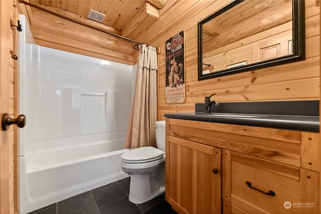 full bathroom with tile patterned flooring, wood walls, vanity, toilet, and shower / bath combo with shower curtain