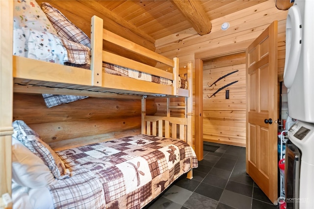 tiled bedroom featuring beamed ceiling, wooden ceiling, and wood walls