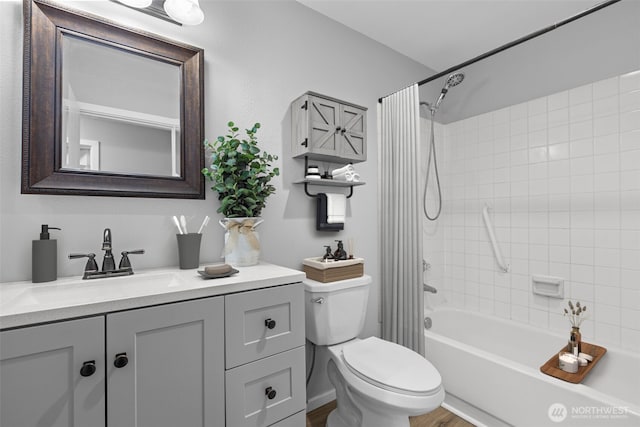 bathroom with shower / bath combination with curtain, toilet, and vanity