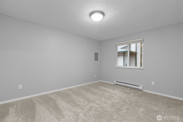 carpeted spare room featuring a textured ceiling, a baseboard heating unit, and baseboards