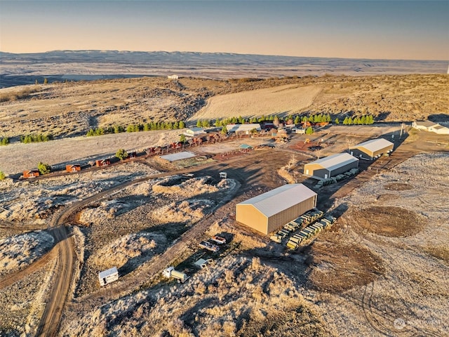 aerial view at dusk featuring a rural view