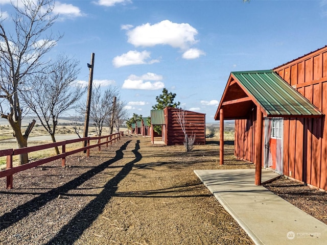 view of yard with a rural view, an outdoor structure, and a playground