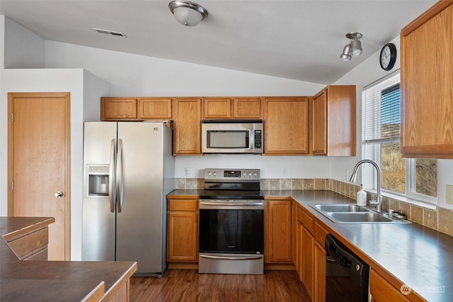 kitchen with dark wood-type flooring, lofted ceiling, stainless steel appliances, and sink