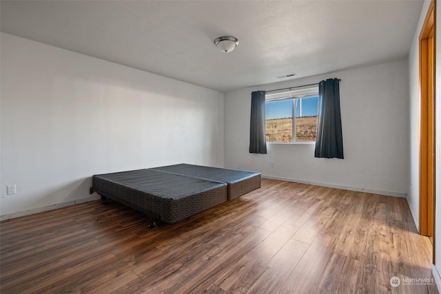 bedroom with wood-type flooring