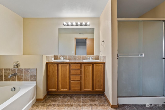 bathroom with independent shower and bath and vanity