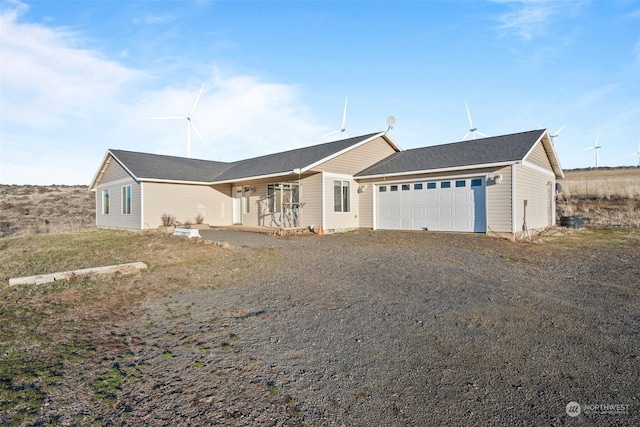 ranch-style house with a garage and covered porch