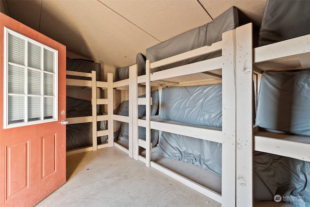 unfurnished bedroom with concrete flooring