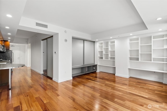 unfurnished living room featuring light wood-type flooring