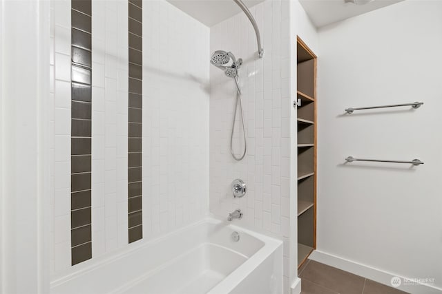 bathroom featuring tiled shower / bath and tile patterned flooring