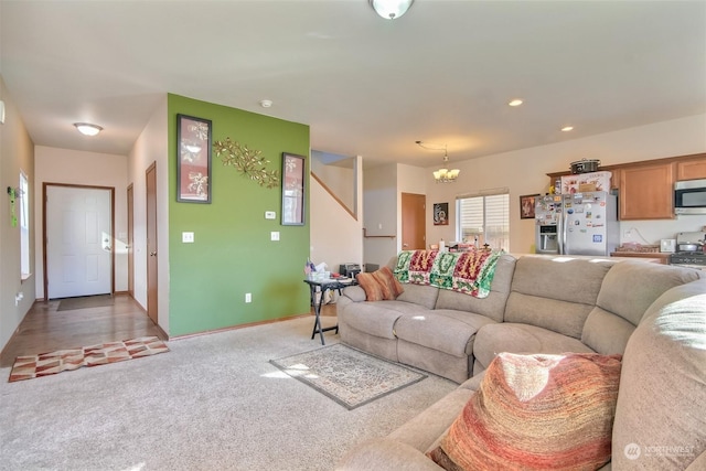 carpeted living room with a chandelier