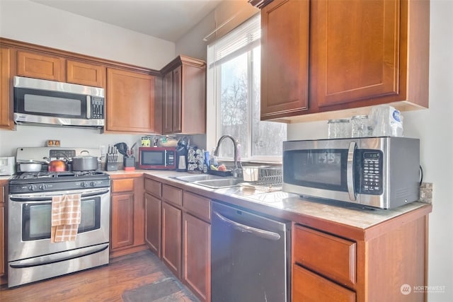 kitchen with sink, dark wood-type flooring, and stainless steel appliances