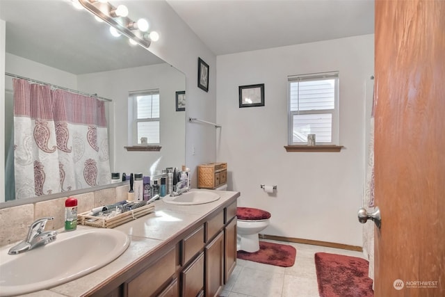 bathroom with tile patterned floors, toilet, and vanity