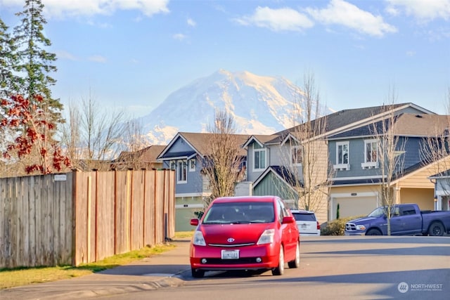 view of front facade with a garage and a mountain view