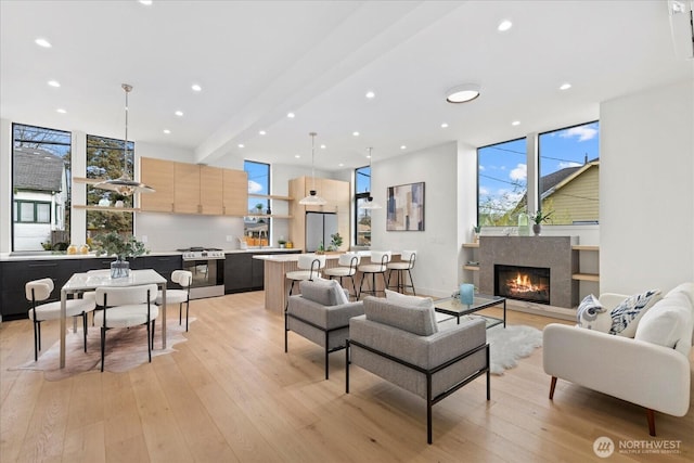 living room featuring beam ceiling and light wood-type flooring