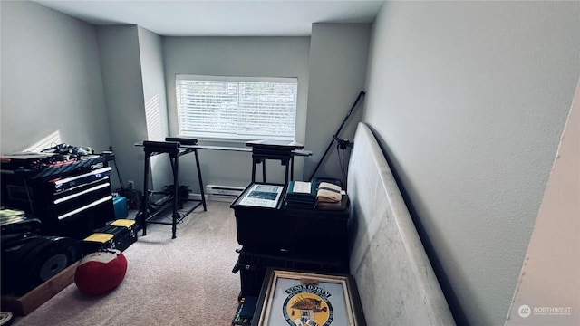 miscellaneous room featuring a baseboard heating unit and carpet flooring