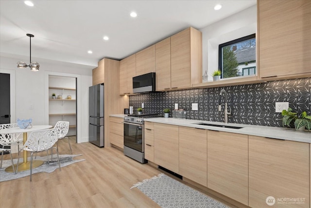 2405 E Fir St B/Adu, Unit B/Adu Seattle, WA 98122 - kitchen featuring pendant lighting, stainless steel appliances, light brown cabinetry, and sink