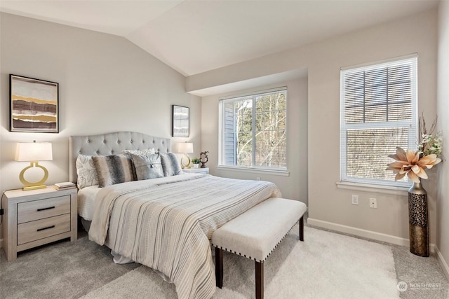 bedroom featuring light colored carpet, lofted ceiling, and multiple windows