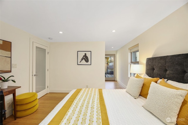 bedroom featuring access to exterior and hardwood / wood-style floors