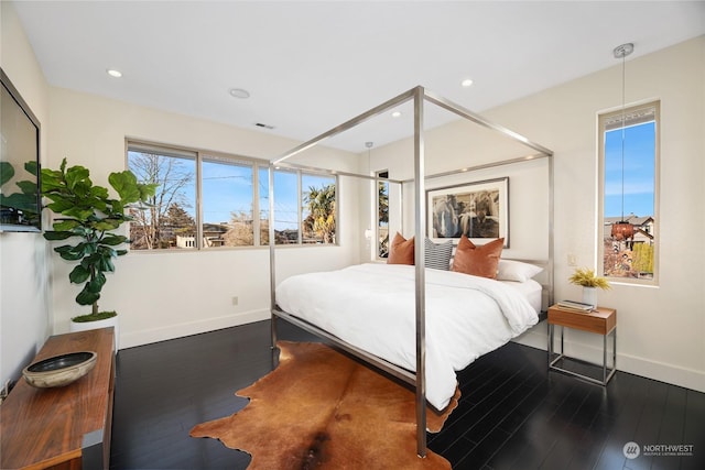 bedroom with dark hardwood / wood-style flooring