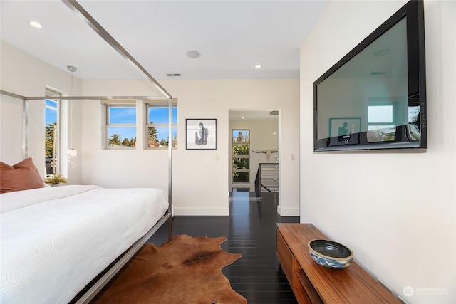 bedroom with dark hardwood / wood-style flooring